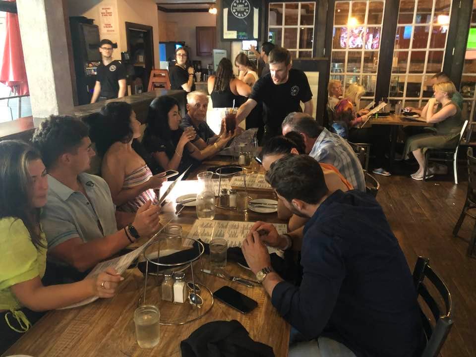 May be an image of 10 people, people studying, table and drink