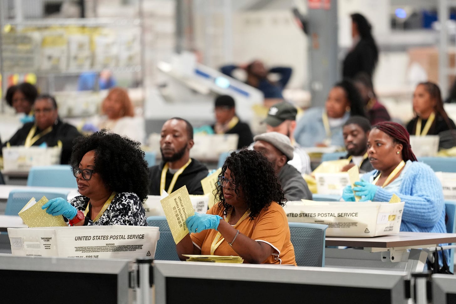 Election workers process mail-in ballots for the general election in Philadelphia in 2024