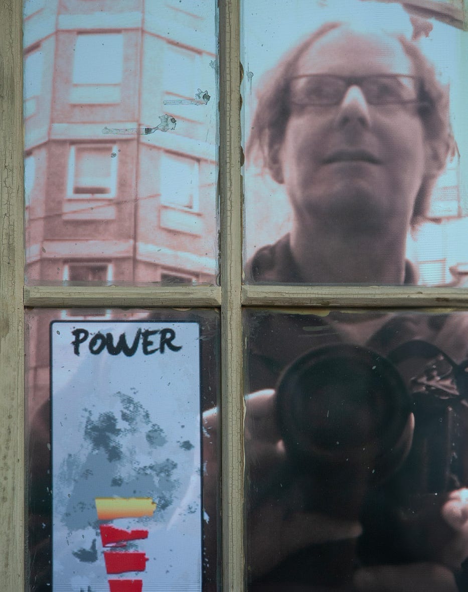 Refection in window pane of writer matthew bamberg
