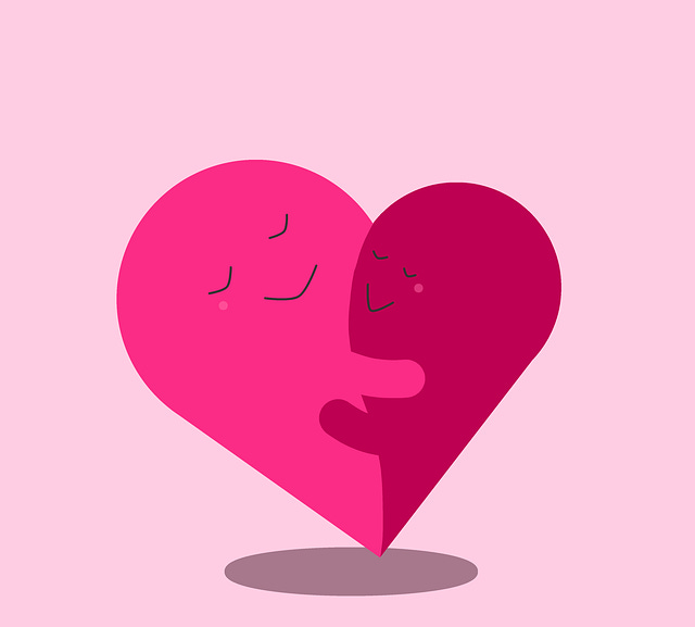 Two pink hearts smiling and hugging each other to show the importance of having compassion towards your anxiety