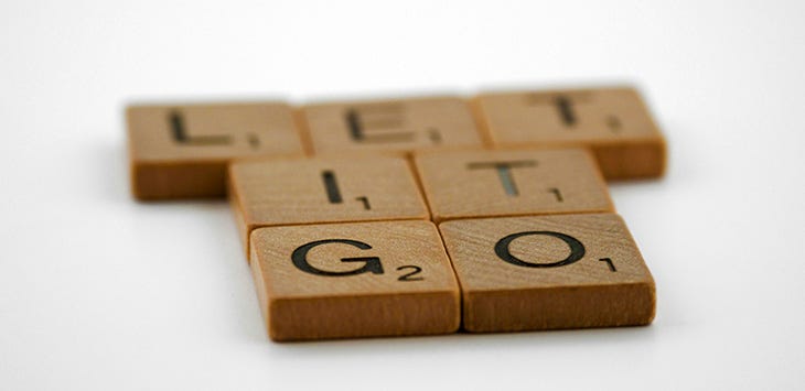 Photo of Scrabble tiles reading 'Let it go'