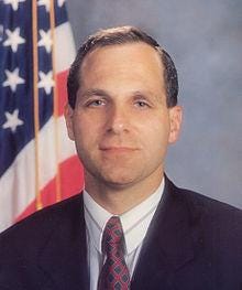 A person in a suit and tie
Description automatically generated with medium confidence A person in a suit and tie
Description automatically generated with medium confidence