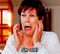 Movie gif. Jamie Lee Curtis as Tess in Freaky Friday looks into a mirror, grabbing her face, and screams, "I'm old!"