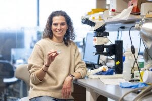 Gili Naveh, associate professor at both Tufts University School of Dental Medicine and Tufts University School of Engineering, in her lab on the Medford/Somerville campus with her cavity-detecting device, the CaviSense.