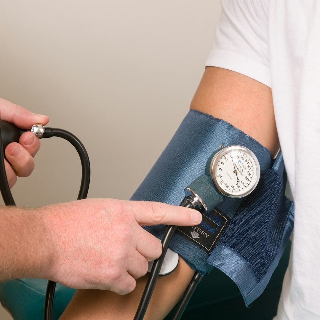 a doctor checking the blood pressure of a patient