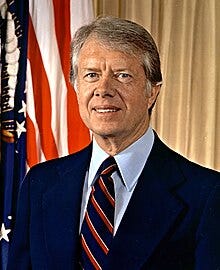 Portrait of Jimmy Carter in a dark blue suit