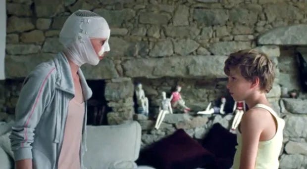 still from Goodnight Mommy, a mother in head wrappings talking to her son