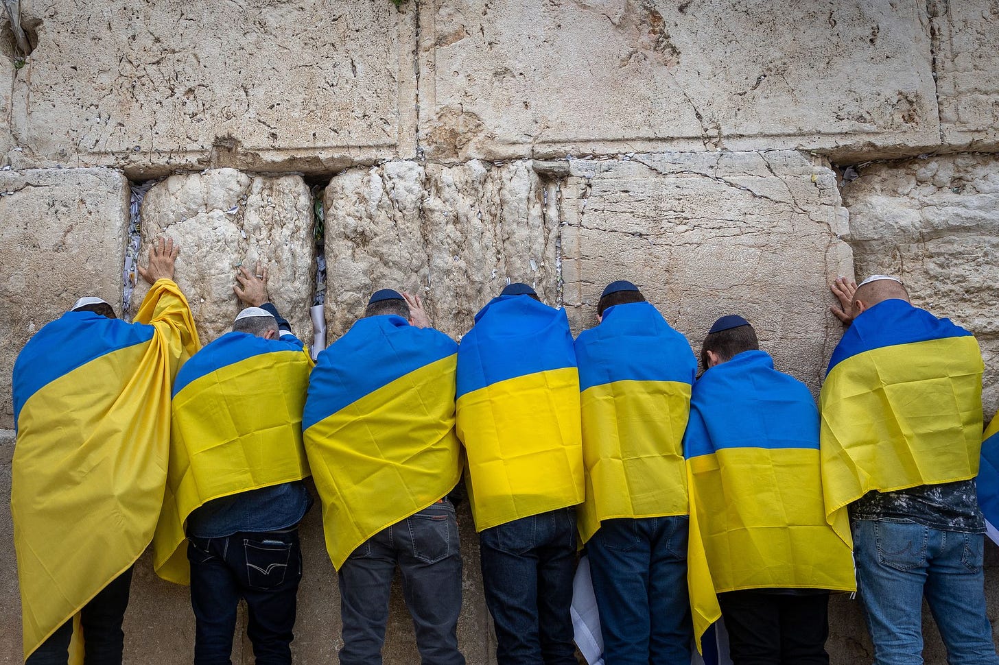Ukraine's ambassador to Israel, Yevgen Korniychuk, Ukrainian citizens and supporters attend a special prayer for the Ukrainian people organized by businessman Arie Schwartz at the Western Wall in Jerusalem's Old City on March 2, 2022. (Photo by Yonatan Sindel/Flash90)