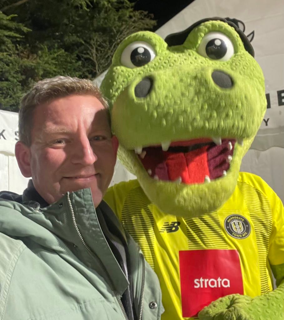 Ben posing with Harrogate Town's mascot, Harry Gator.