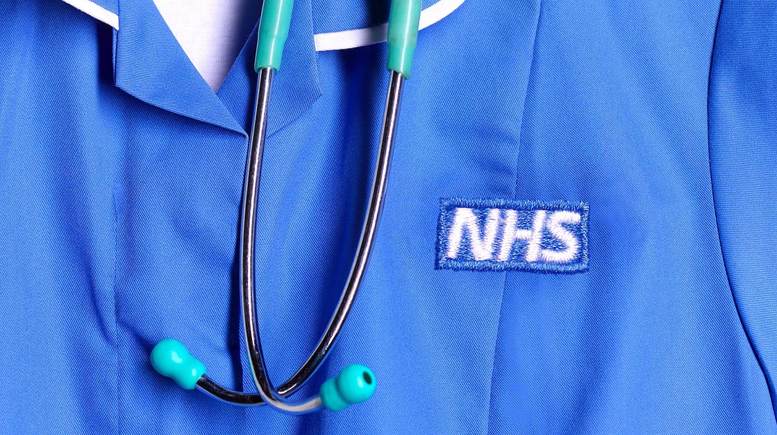 An close-up image of someone wearing NHS branded scrubs