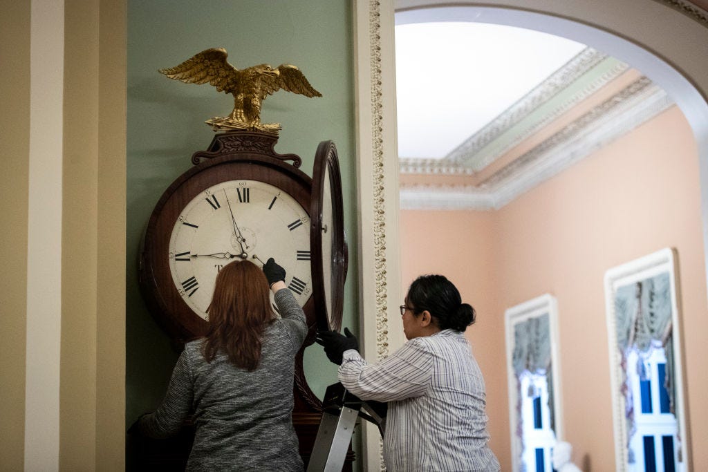 WASHINGTON, DC - JANUARY 21: Staff members with the Architect of the Capitol wind the Ohio Clock at the U.S. Capitol. (Photo by Drew Angerer/Getty Images)