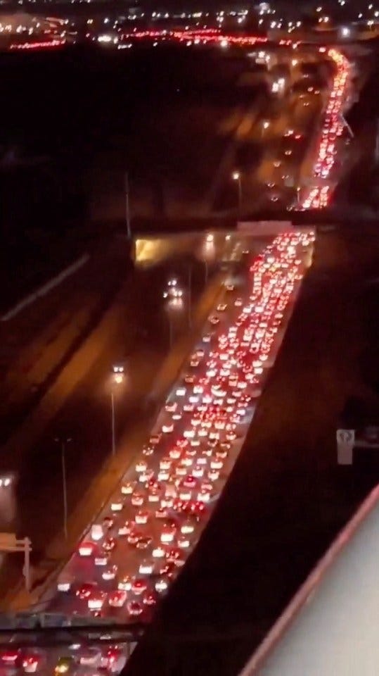 Aerial view of a highway traffic jam at night.