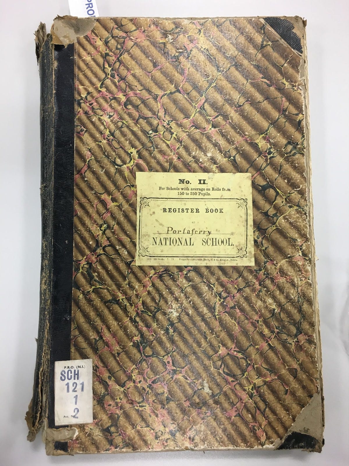 A worn school register book inscribed for Portaferry National School