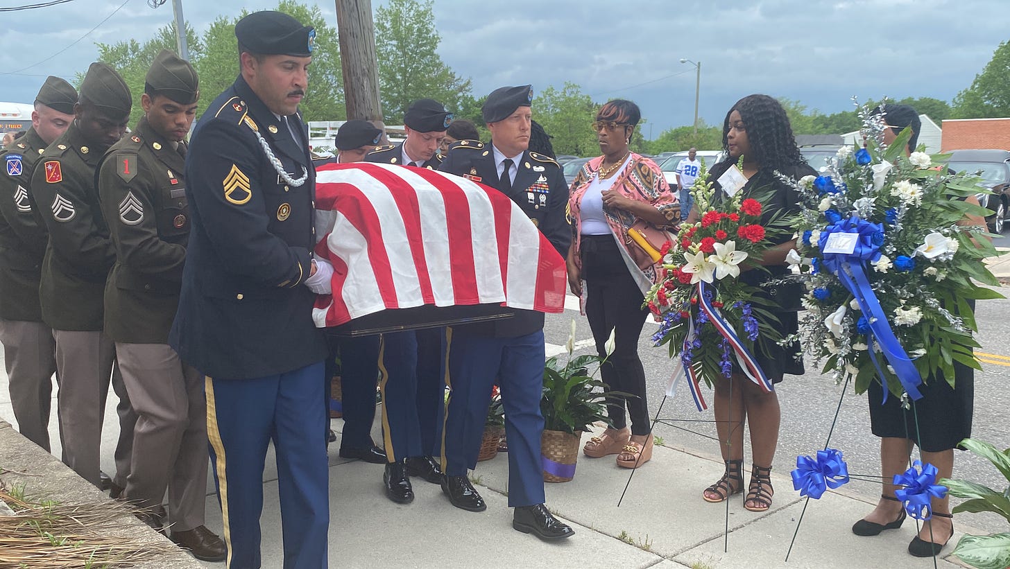 The coffin of Richard Stewart is carried by an honor guard after his funeral in Petersburg 