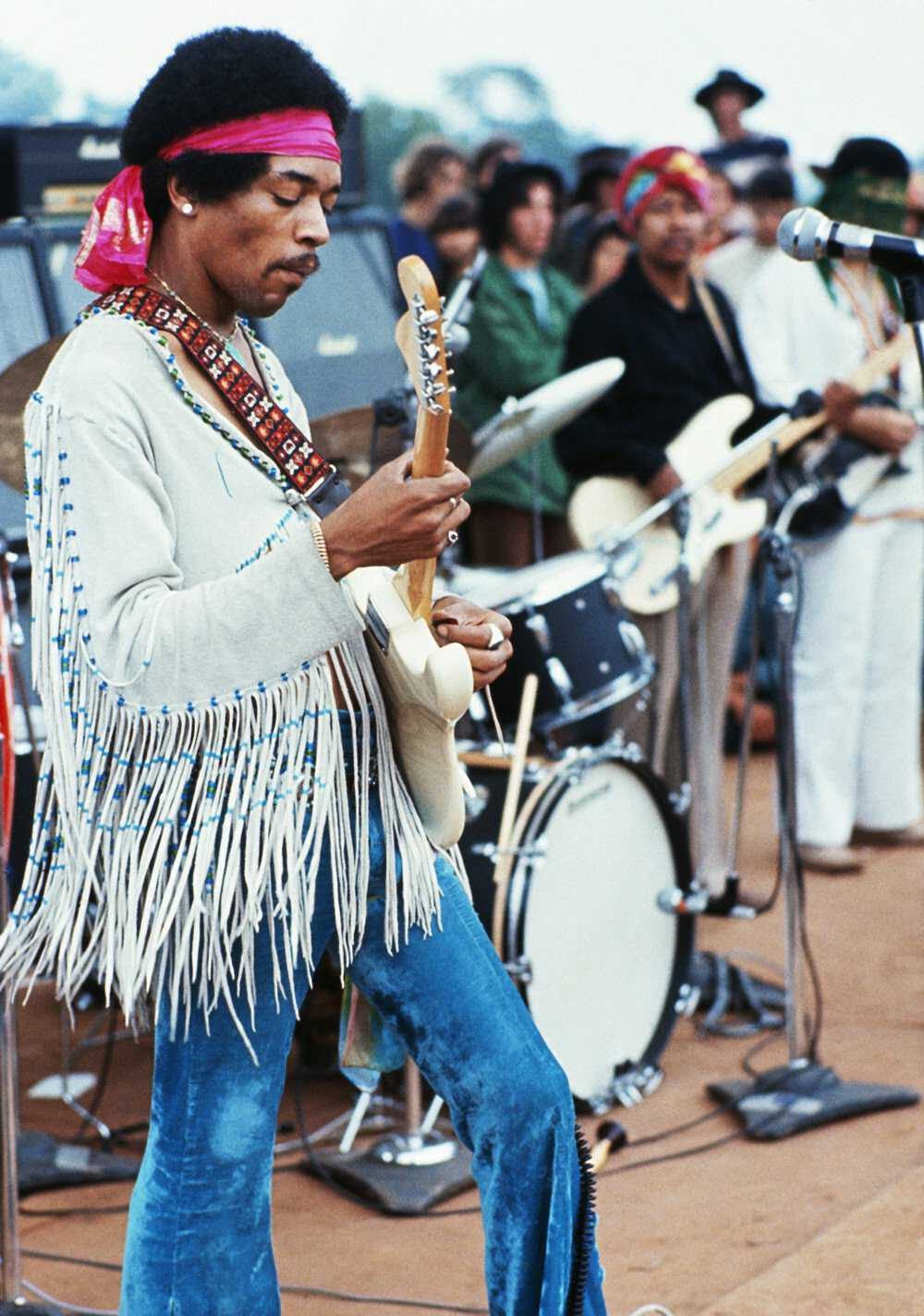 Jimi Hendrix playing his guitar during his set at the Woodstock Music and Art Fair. Playing with Jimi Hendrix is Billy Cox. 