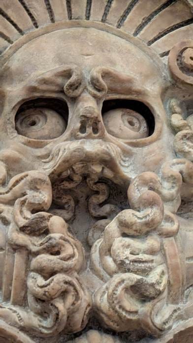 A stone sculpture of a person with eyes and mouth

AI-generated content may be incorrect.