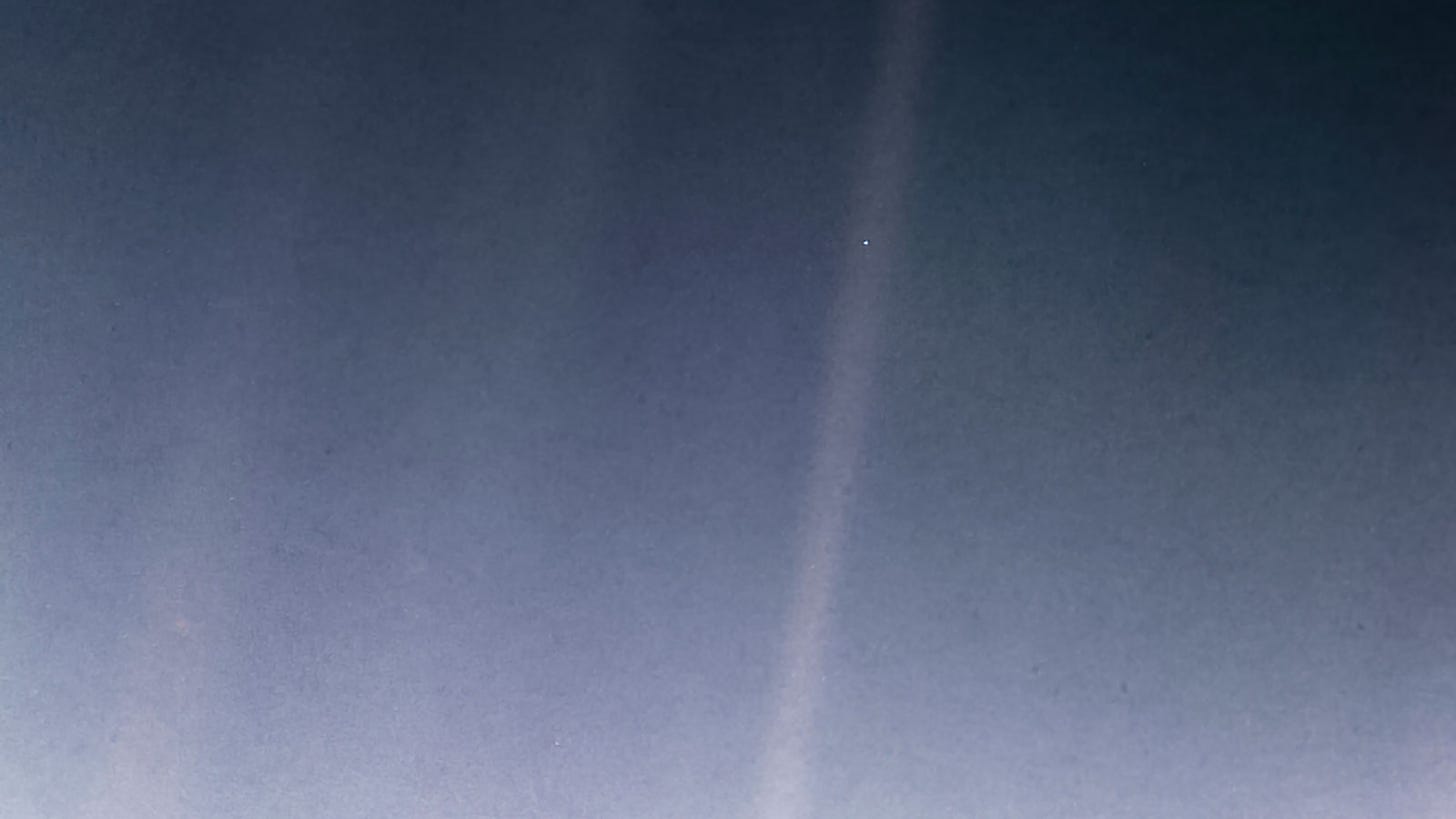 Earth as a small blue dot in a fuzzy beam of light.