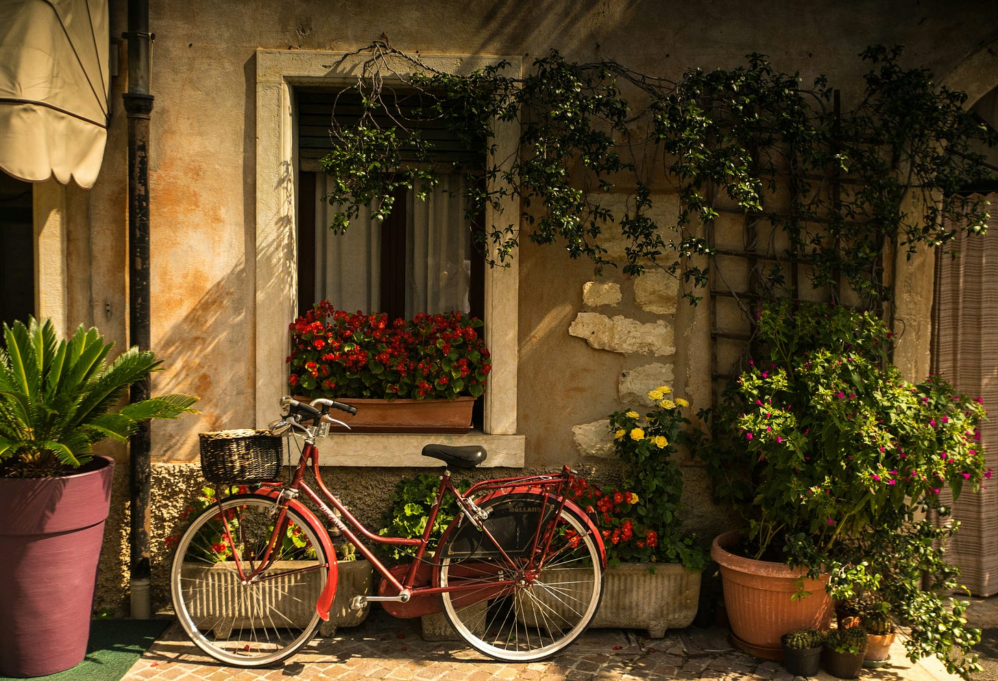 italian stone cottage with red bike parked in front