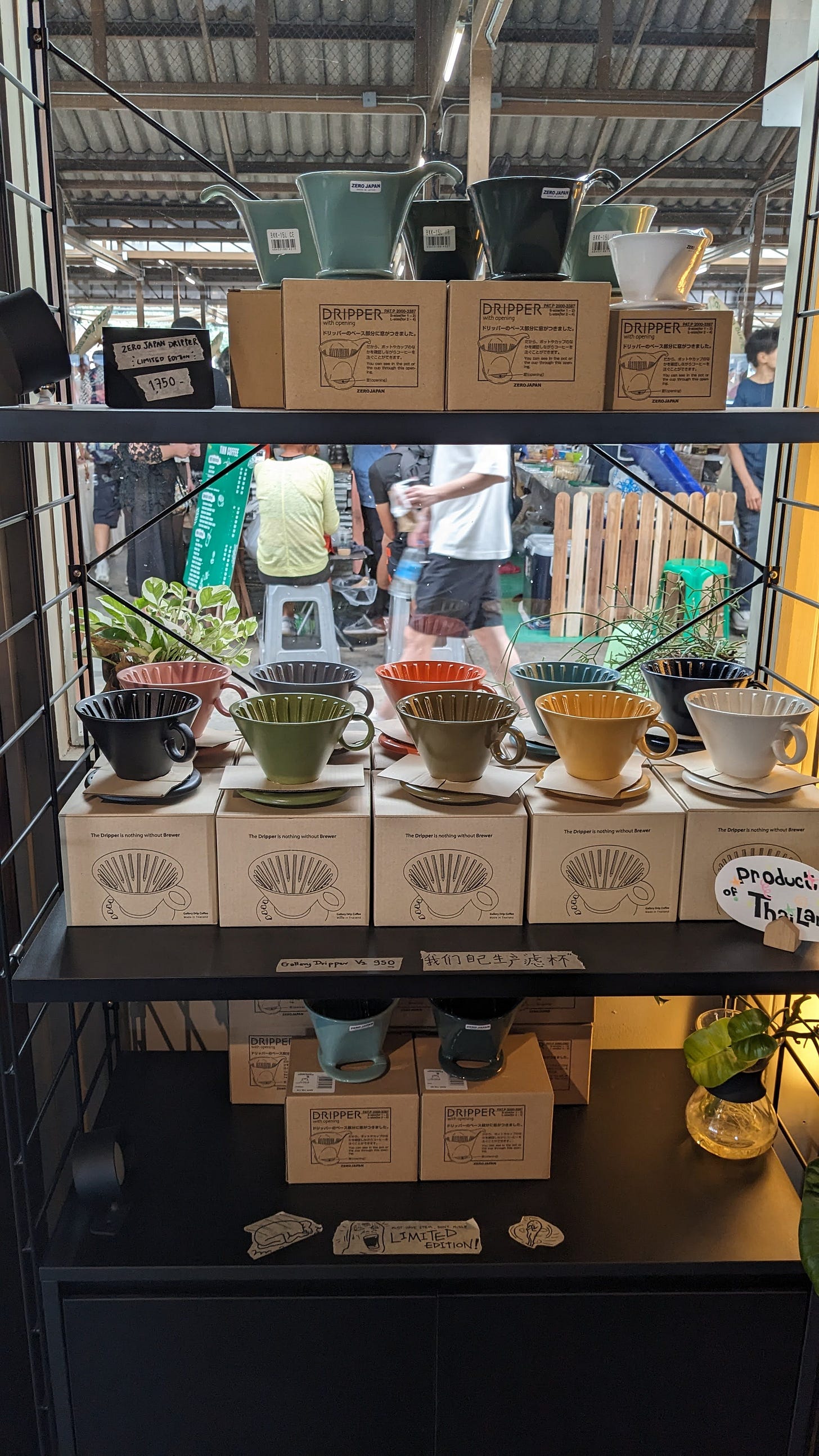 a shelf of colorful ceramic coffee pour overs
