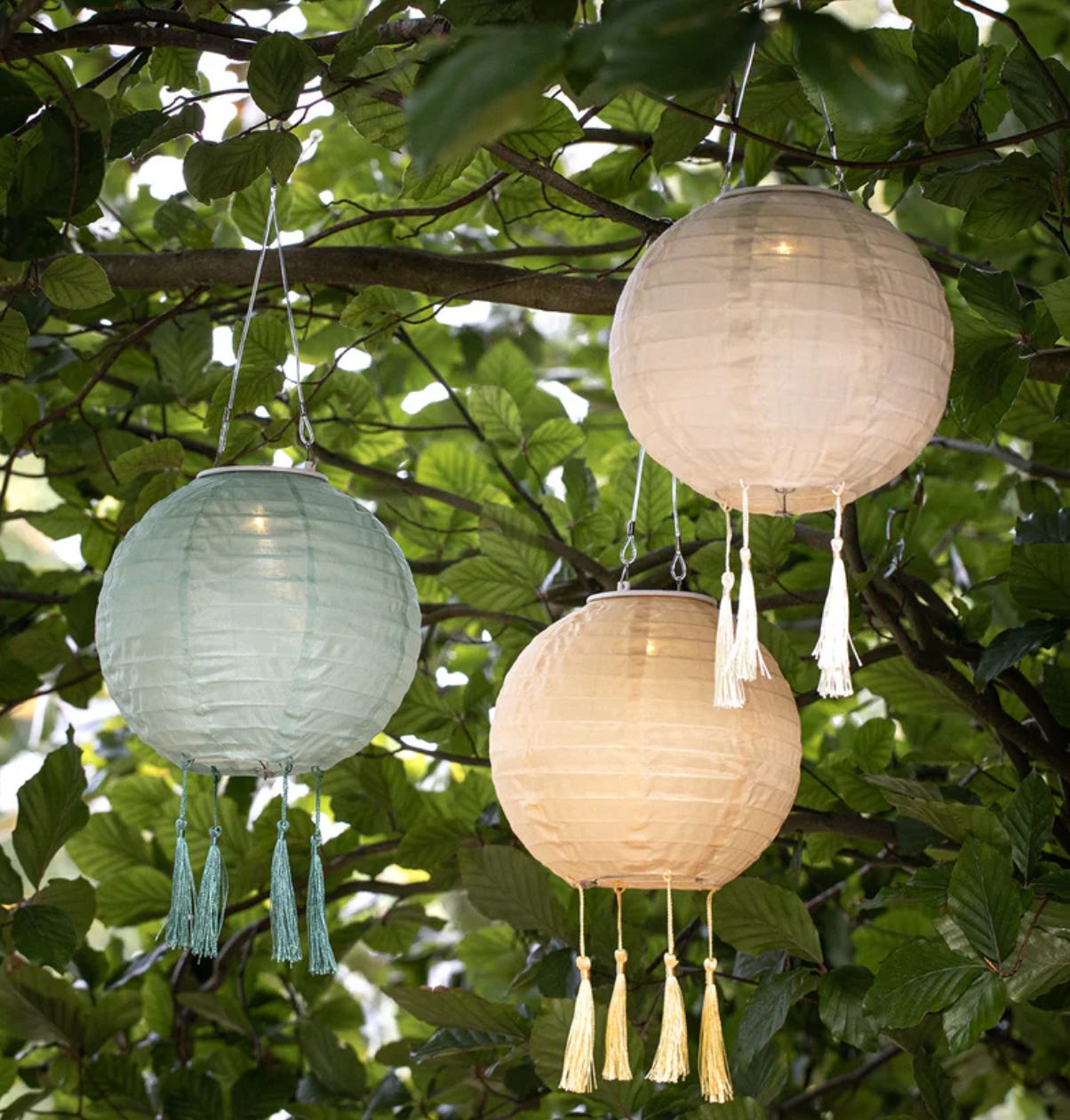 a trio of lanterns with tassles