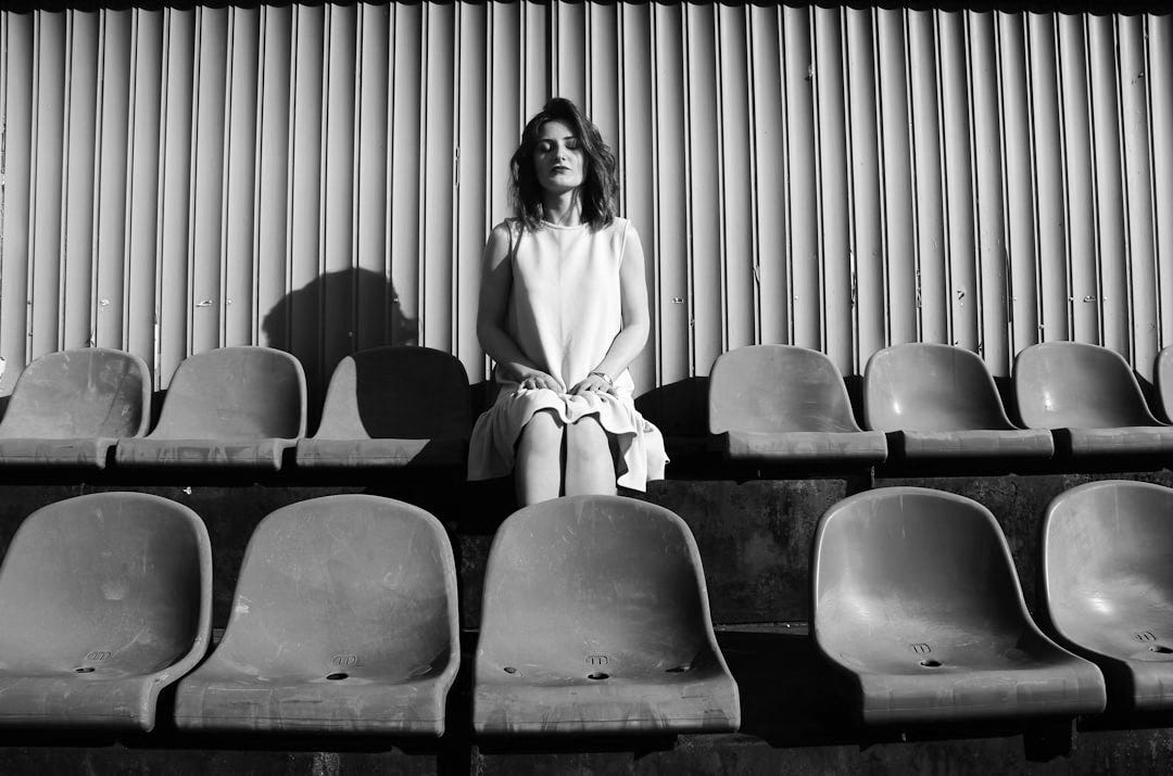 woman sitting on gang chair woman sitting on gang chair