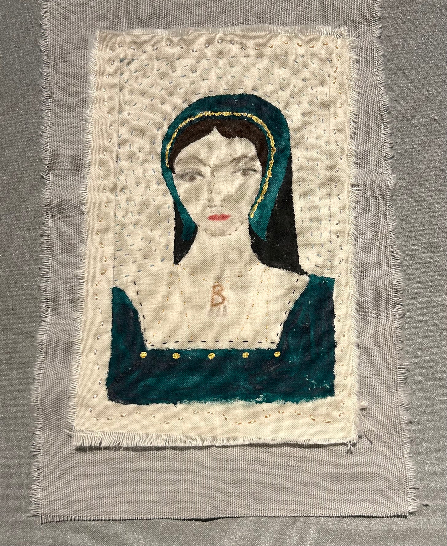 A stitched portrait of Anne Boleyn, wearing green and her famous B necklace.