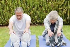 Two seniors doing stretching exercises