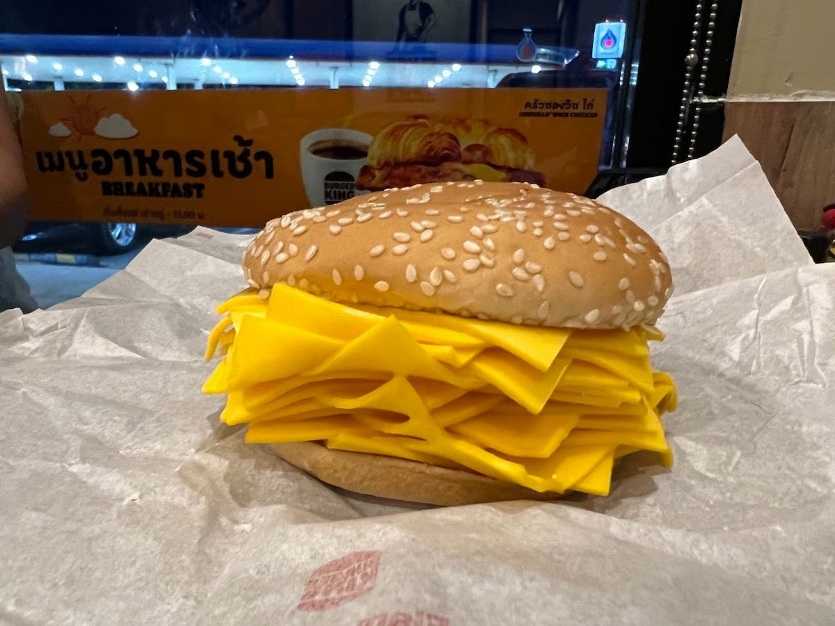Picture of the “Real Cheeseburger.” It’s just a bun with a heap of American cheese slices on it. It’s like saying “fuck you” in the form of fast food.