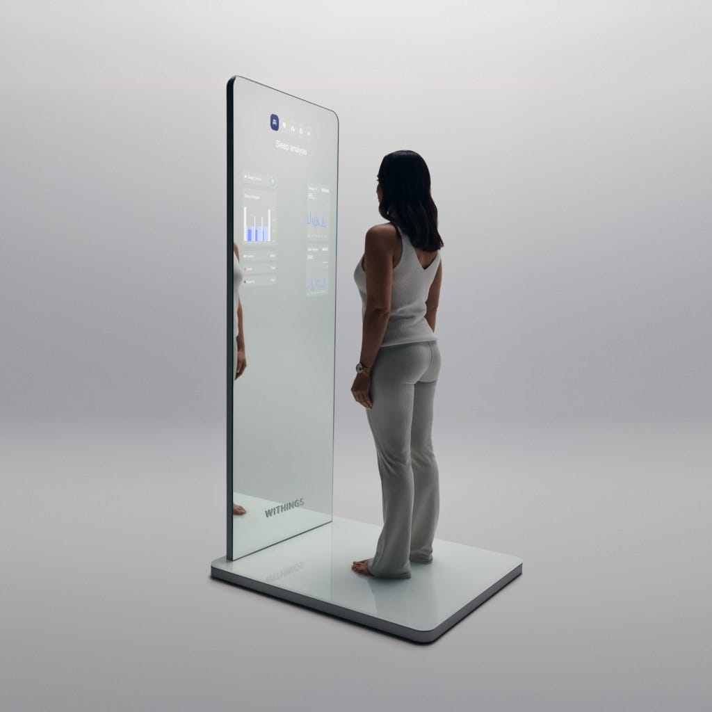 woman standing on a Withings Omnia, a full-size body-scanning health mirror