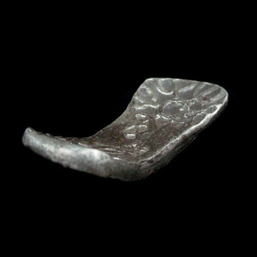 ancient-indian-silver-bent-bar-shatamana-coin_from the Gandara Kingdom India circa 600 BC stock number e8197c