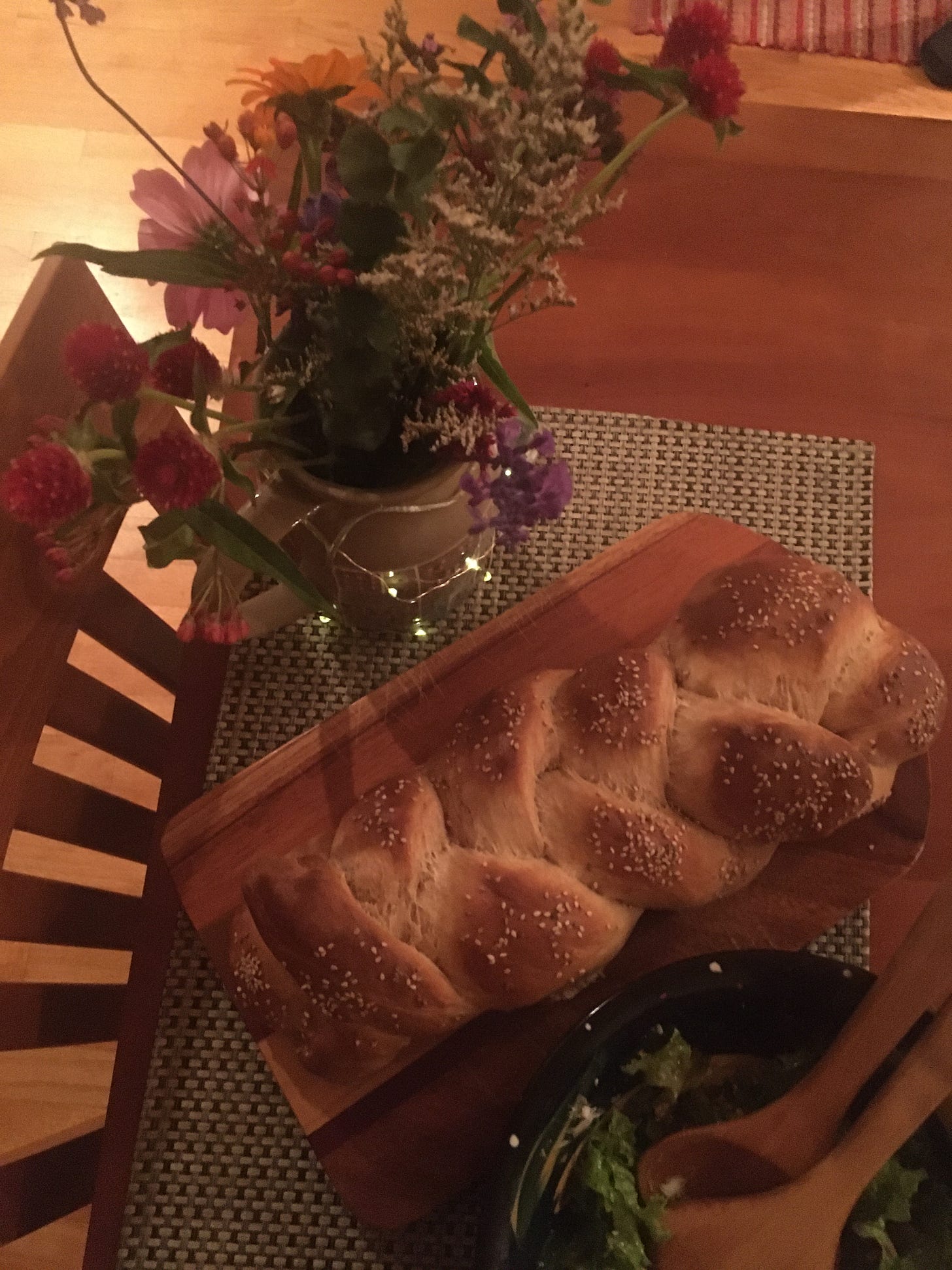 flowers, challah, salad on table