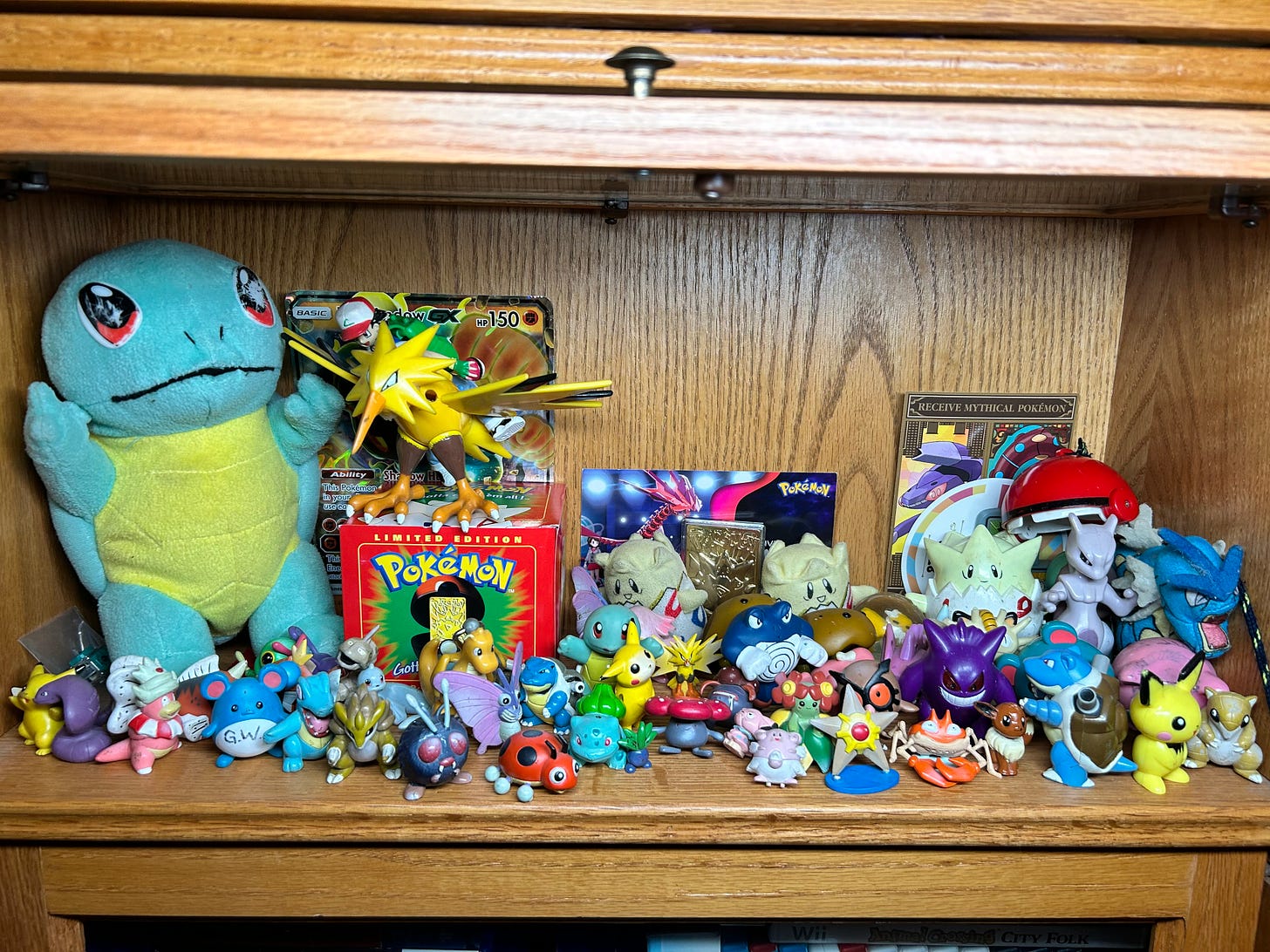 This is a selection of Ethan's childhood Pokémon toys, mostly obtained between 1999 and 2000. He claims this is probably his favourite part of his entire Pokémon collection. He has a lot of Tomy and Burger King toys, along with a gold-plated Togepi card and plushies