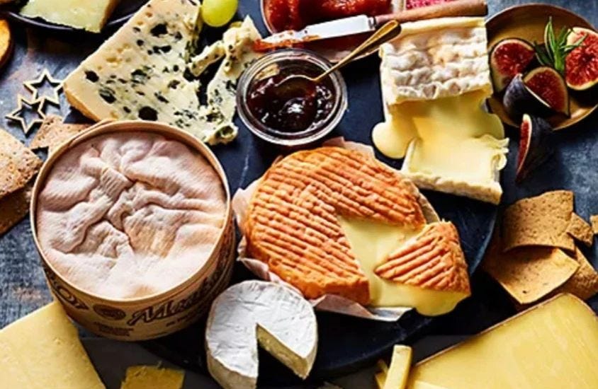 A selection of European cheeses, with fruits and chutneys
