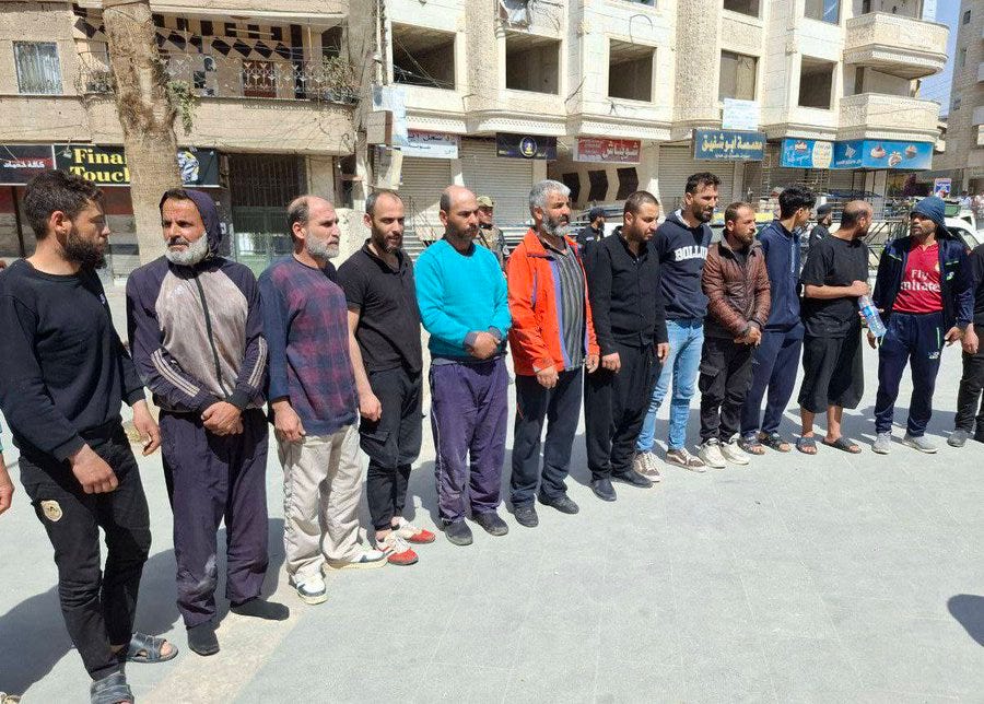 A group of men standing in a line

AI-generated content may be incorrect.