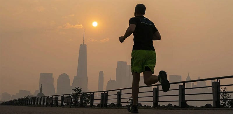 A man running with a city skyscape in the background