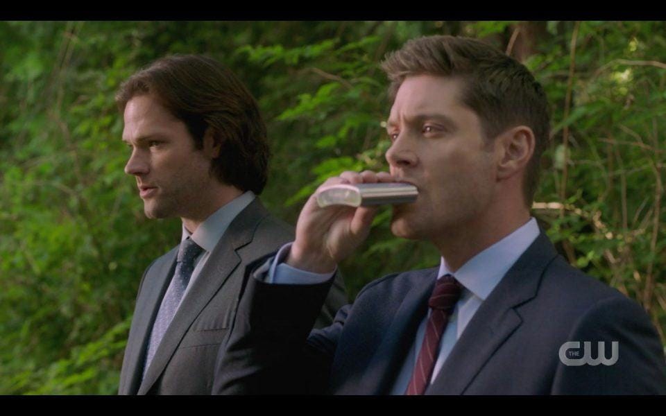 Dean Winchester taking drink from flask in front of Sam SPN 1504