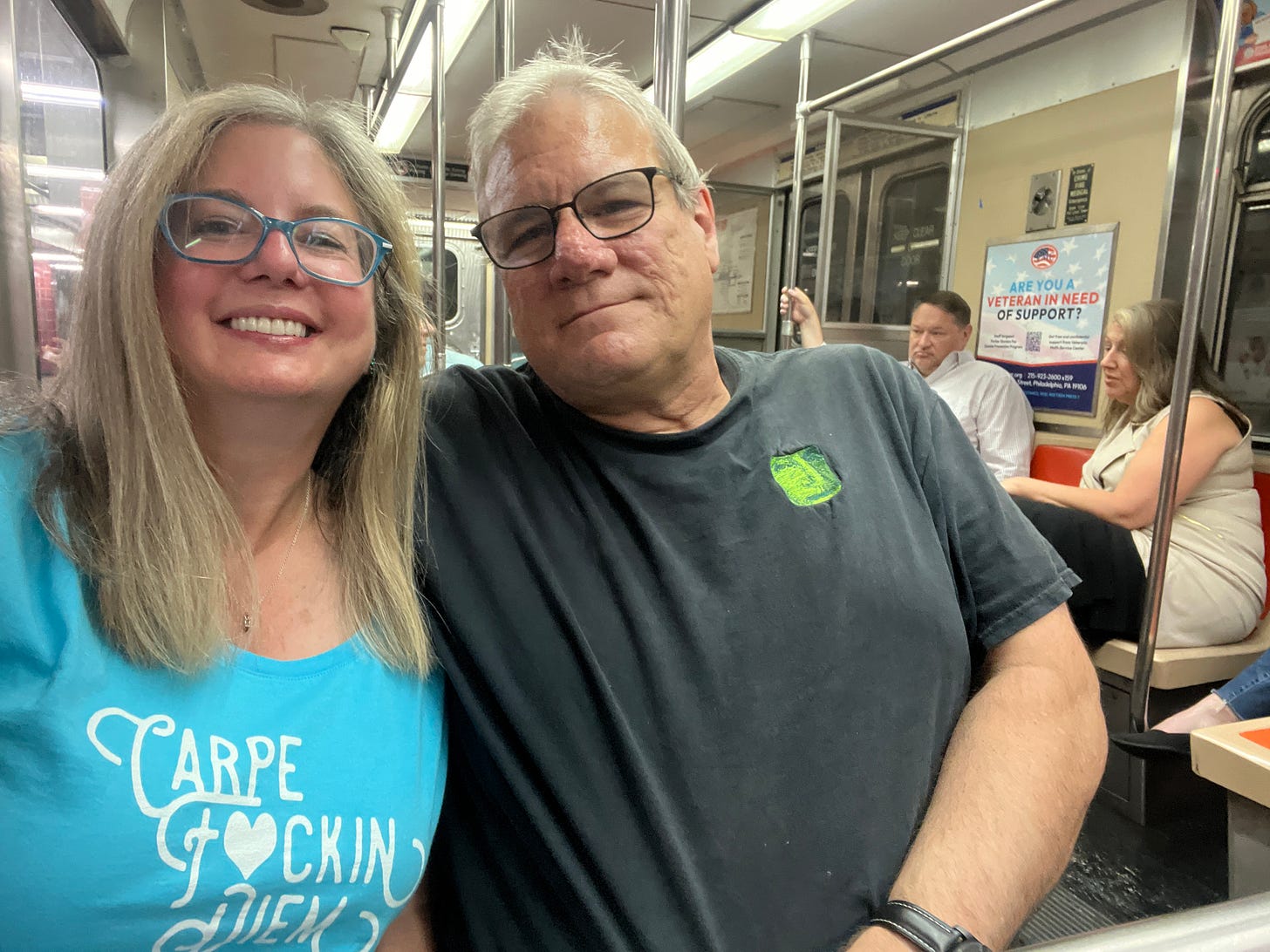 Picture of man and woman in subway woman wearing carpe fucking diem t-shirt