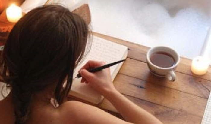 woman writing while in bathtub