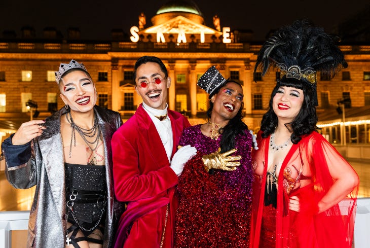 Four young people dressed festively in front of Somerset House