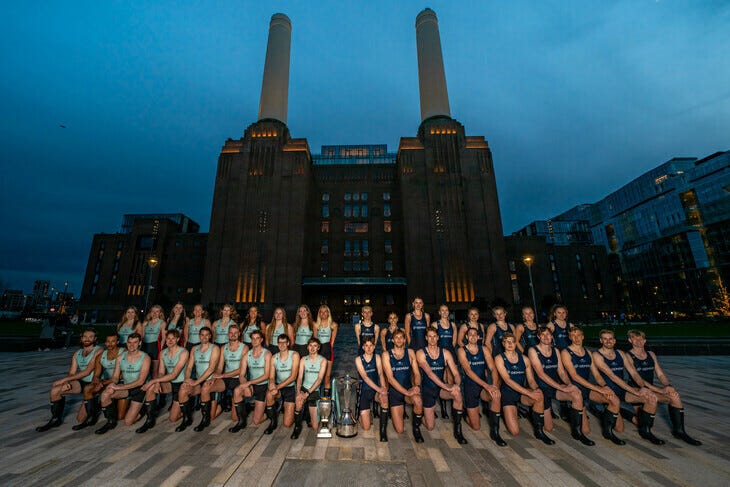 Boat race competitors posing in front of Battersea Power Station