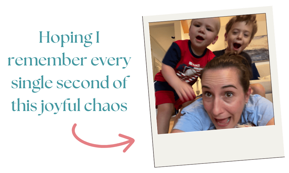 mom on the ground with her two boys jumping on top of her mom on the ground with her two boys jumping on top of her