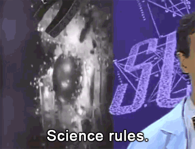 A gif from the TV show "Bill Nye the Science Guy." The camera pans over Bill as he says "Science rules." The gif changes from standard color to a fuzzy green, like an old computer glitching. An explosion goes off behind Bill and the word "Science" floats by.