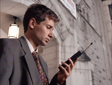 A man holds a cell phone with a text message that says bye bye A man holds a cell phone with a text message that says bye bye