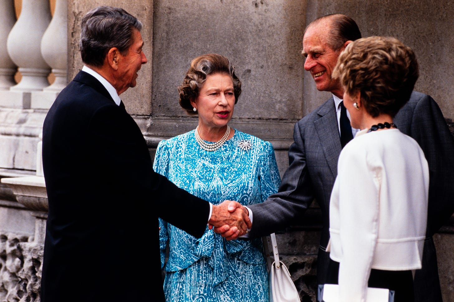 Prince Philip shaking hands with Ronald Reagan