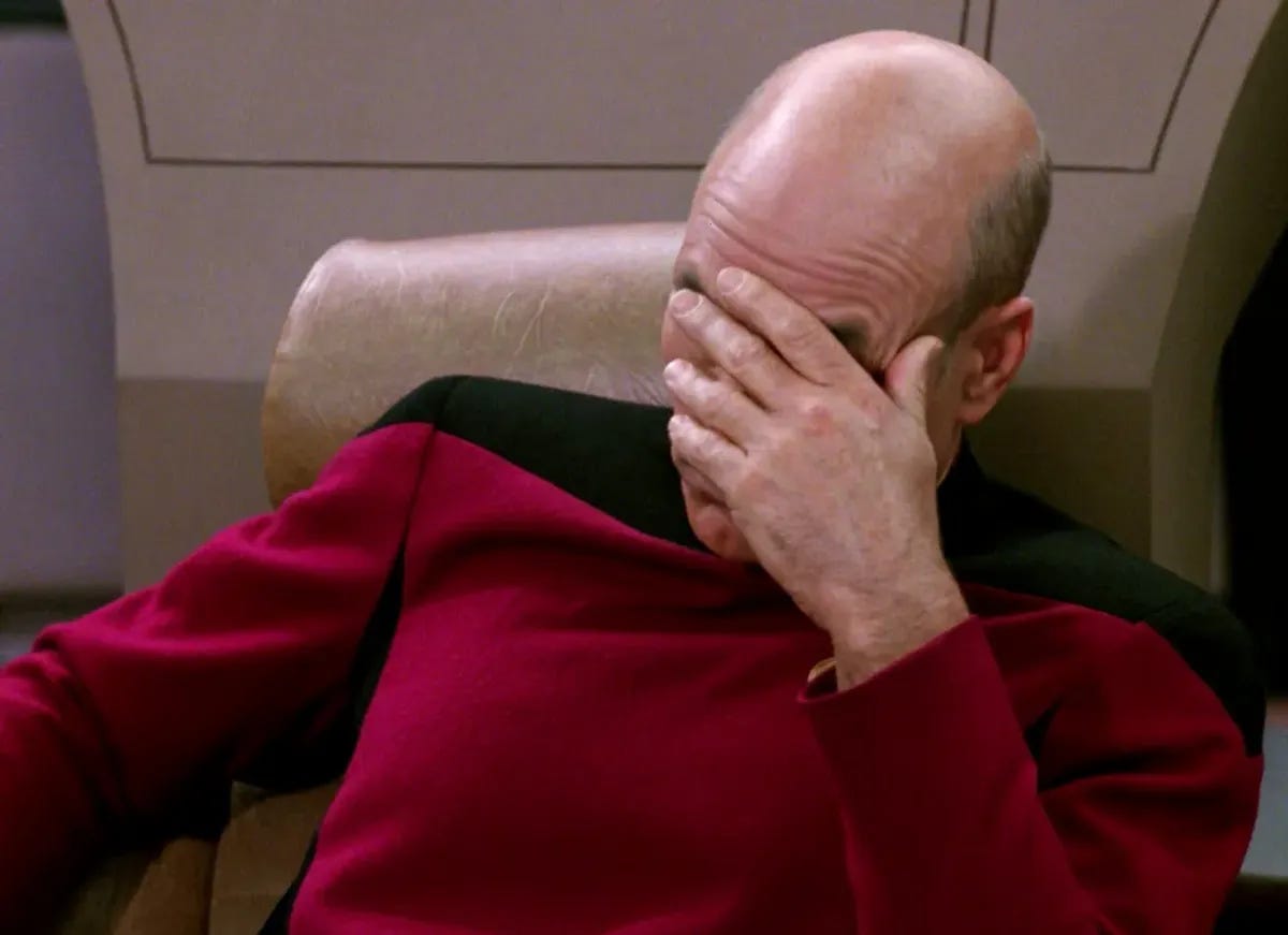 Captain Picard from Star Trek face-palming. He is wearing a red and black uniform.