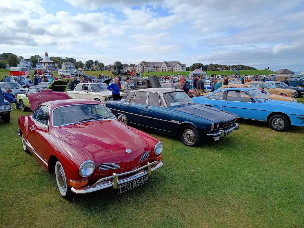 Classic cars parked on the grass at the Links