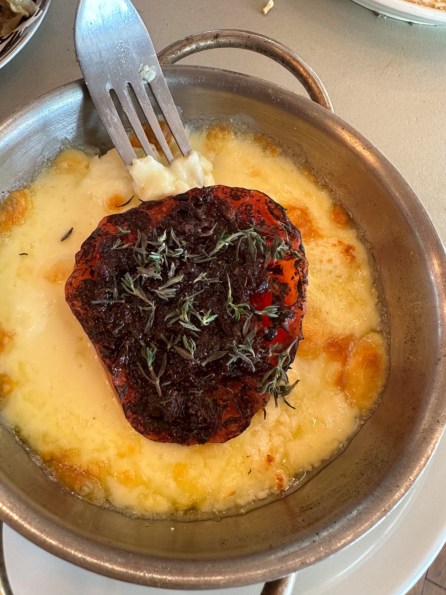 Melted cheese with roasted tomato at Maslow vegetarian restaurant in Paris.jpg