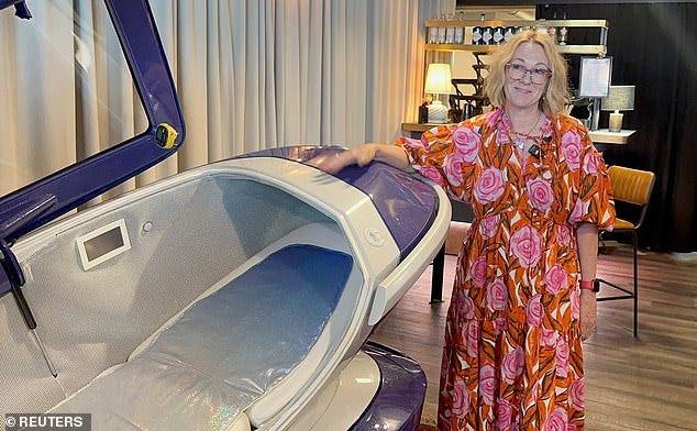 Fiona Stewart, member of the Last Resort poses next to the Sarco suicide machine in July