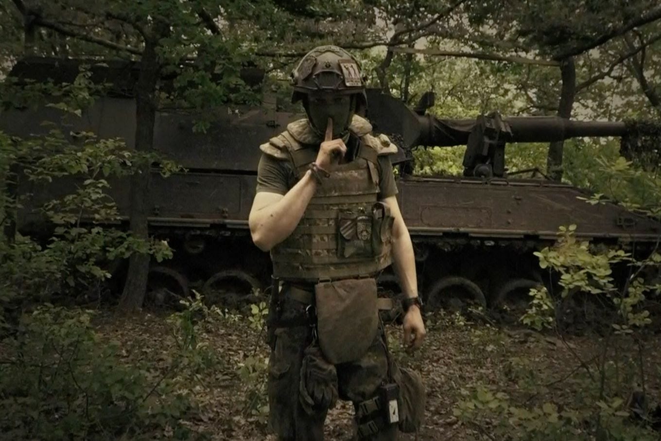 In an image from video provided by the Ukrainian Defense Ministry on June 4, a soldier poses with a finger to his lips in an undisclosed location in Ukraine. (Ukrainian Defense Ministry/AP)