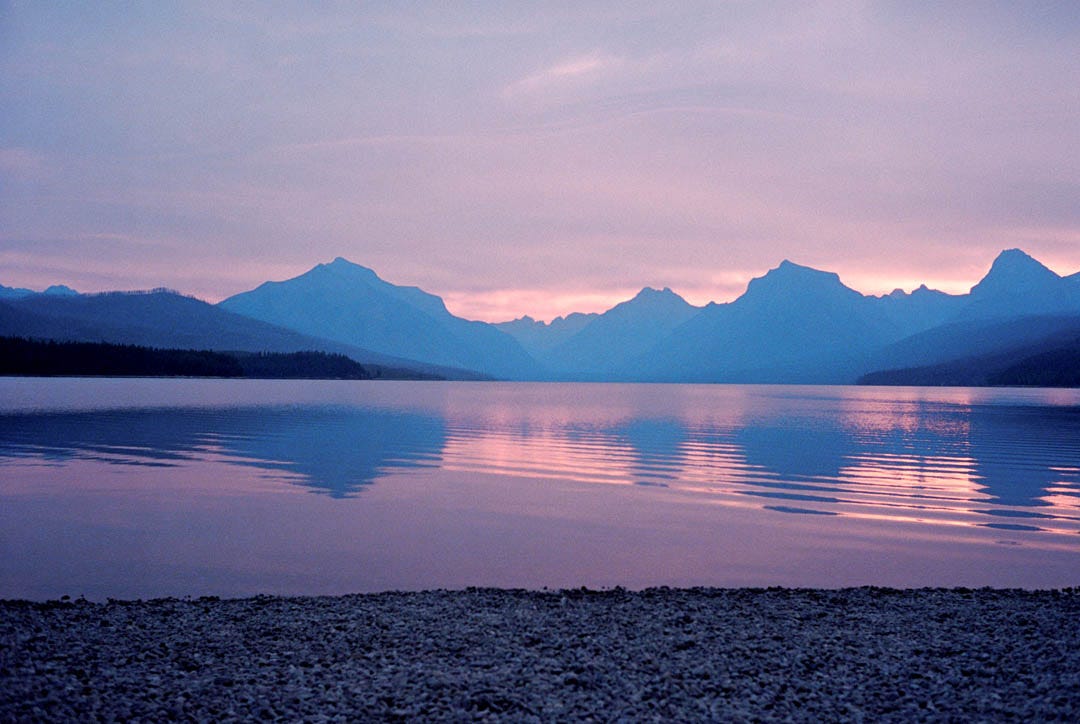 A photo of a lake in soft morning light.